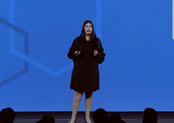 A women giving presentaion on stage